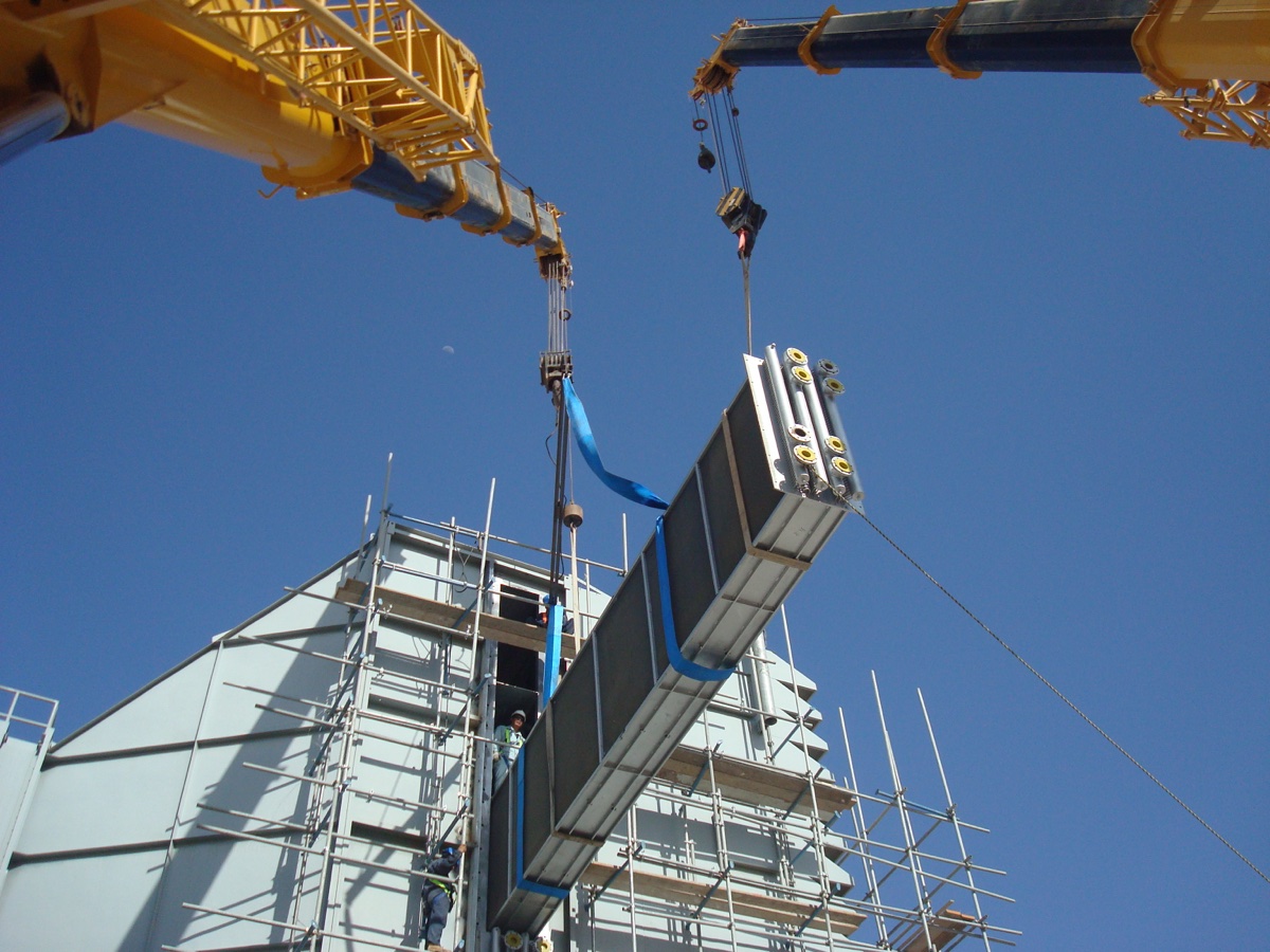 Gas turbine inlet air cooler being lifted by crane at project site